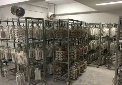 What is the coating process in investment casting?